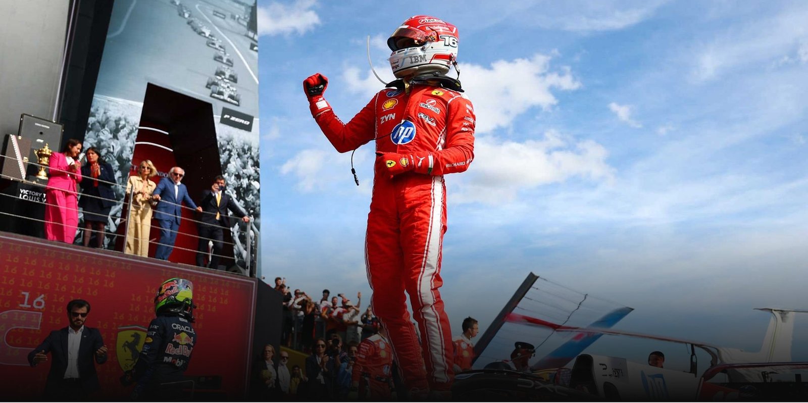A driver celebrating on the podium